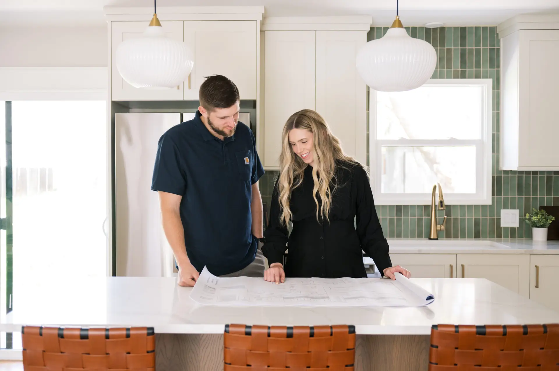 Kole and Katie Bailey looking at a floor plan