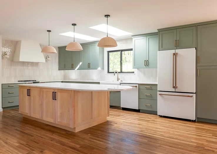 Green kitchen with maple island white countertops and island pendants